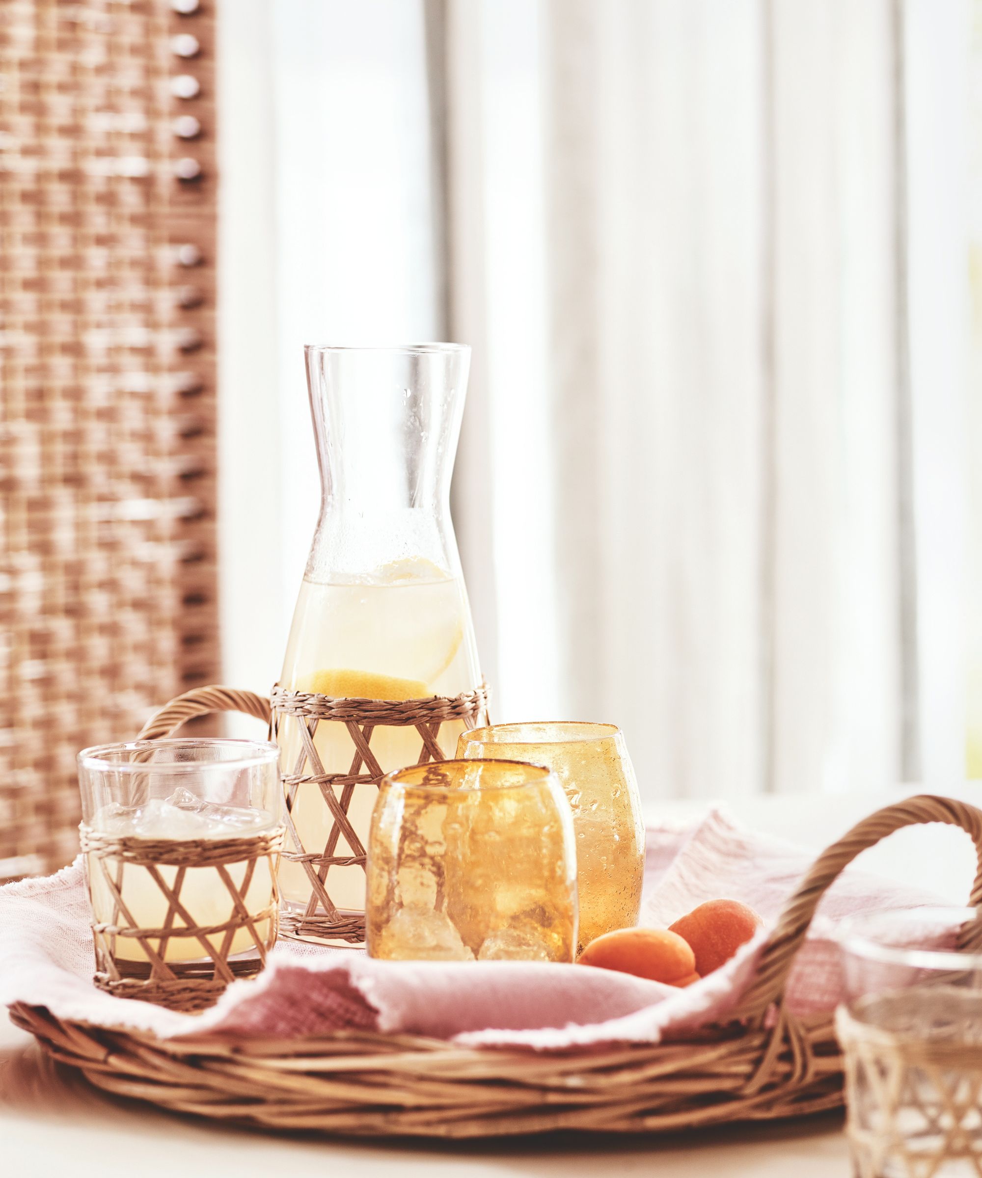 Glass carafe and yellow tumblers