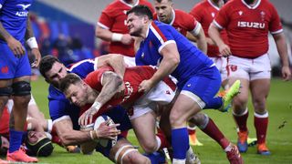 Dan Biggar of Wales scores his sides 1st try as Charles Ollivon and Julien Marchand of France attempt to tackle during the Guinness Six Nations match between France and Wales