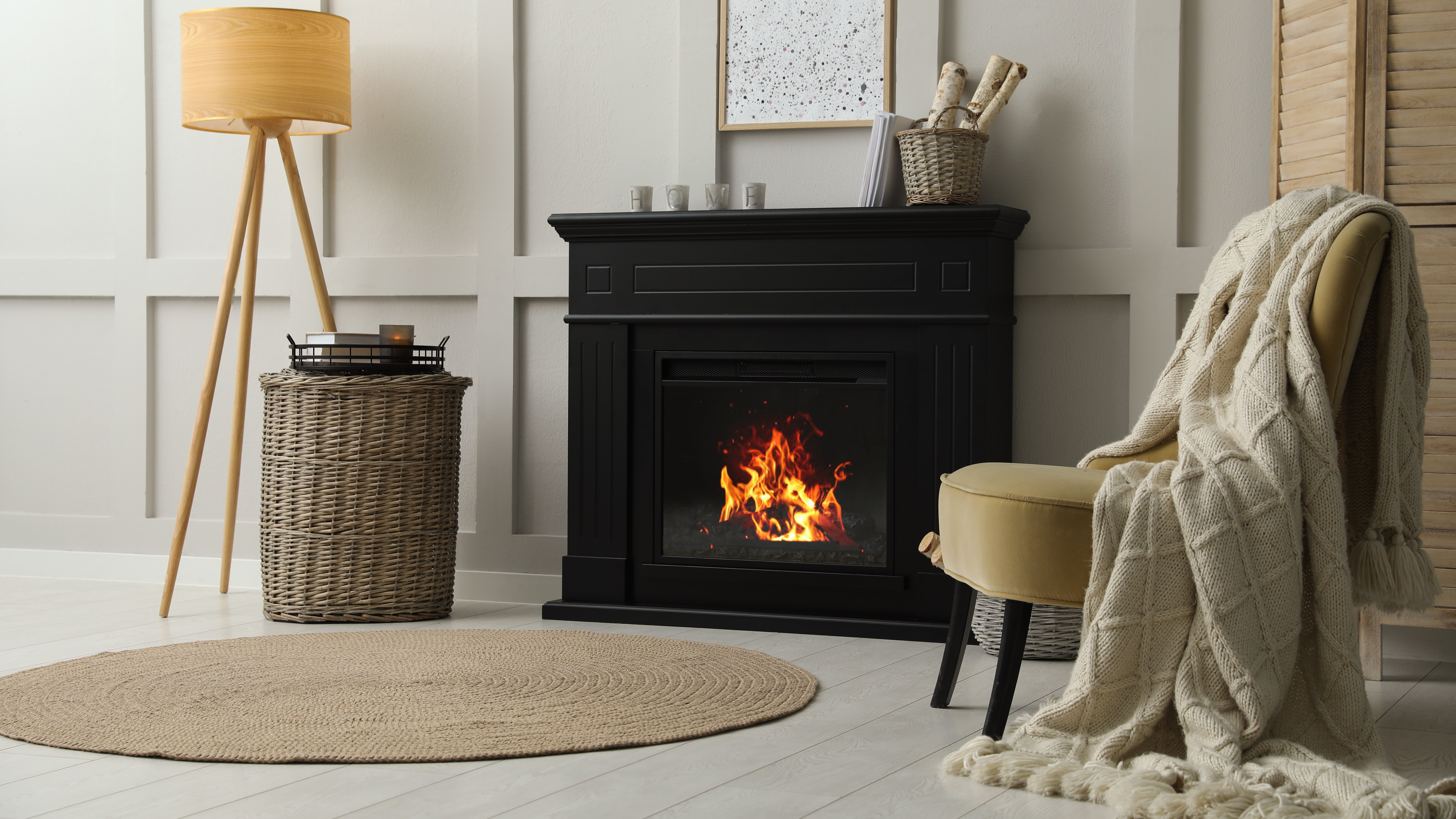 Cosy living room with black fireplace and armchair 