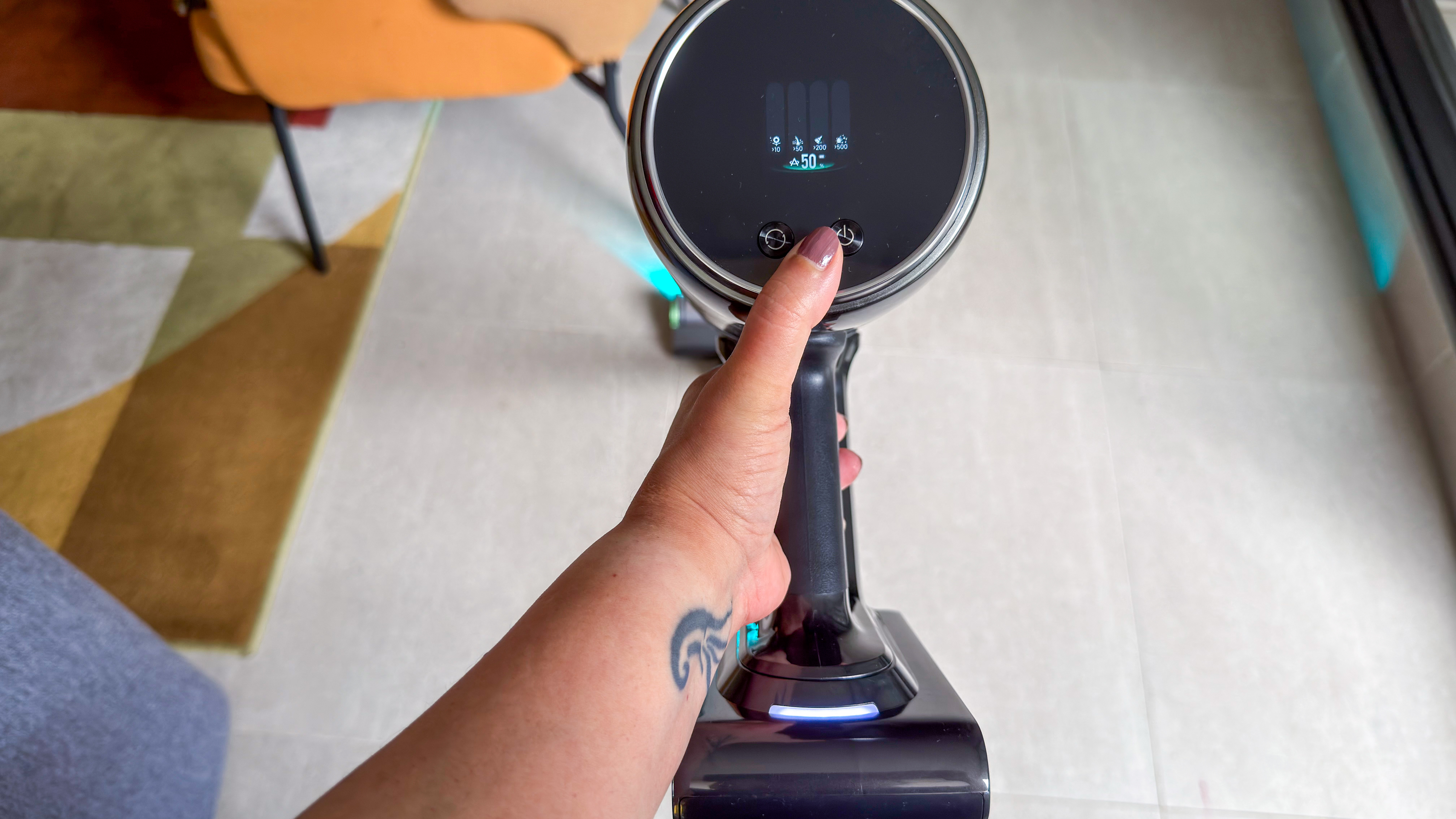 A person using the Dreame Z50 Station on hard floors