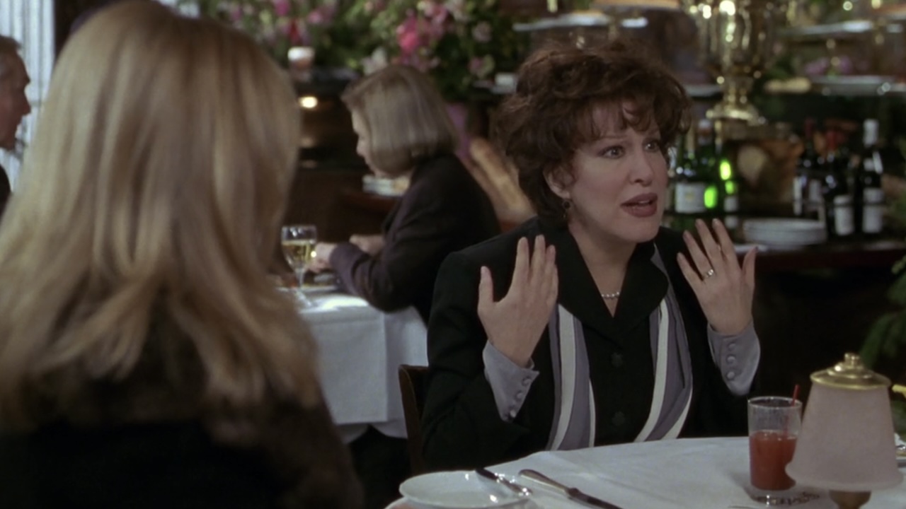 Brenda talking at the table in The First Wives Club