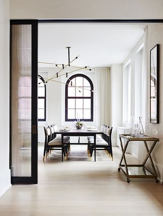 Dining room with wooden floors and arched windows