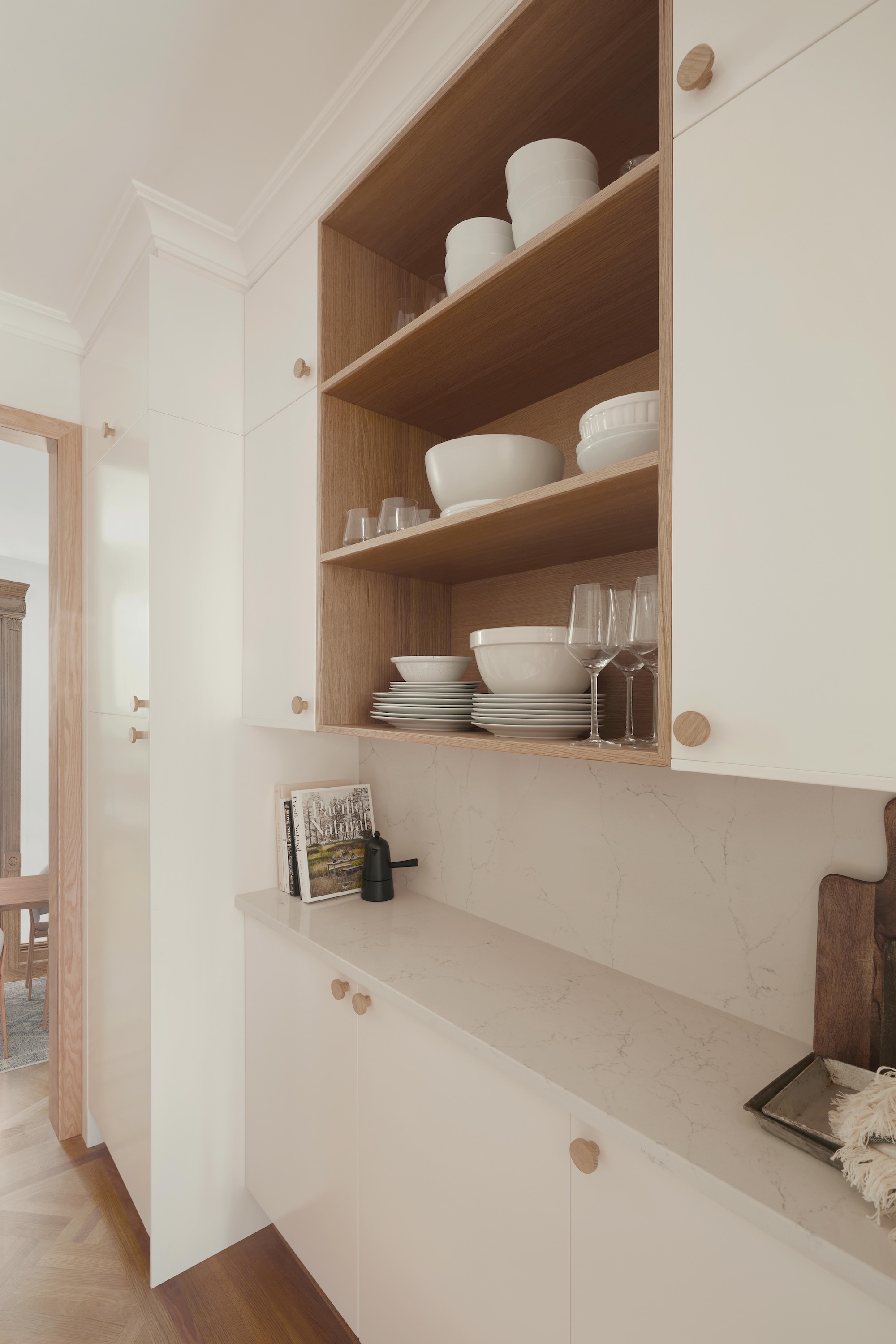 A white and wood kitchen with open shelving to display frequently used crockery and glassware