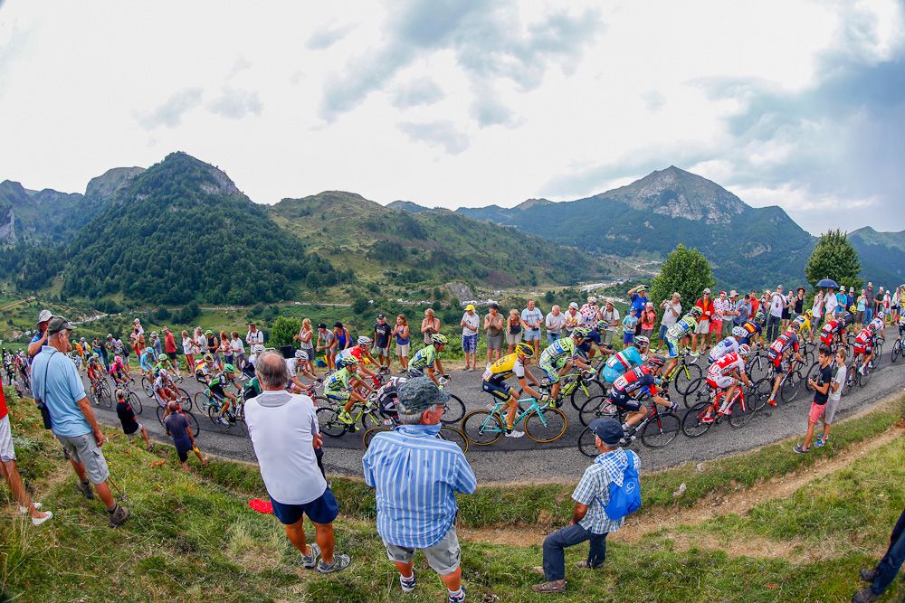 Spectators line the road as the peloton climbs.