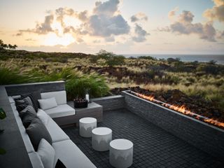 An outdoor area with a long wall for a fireplace