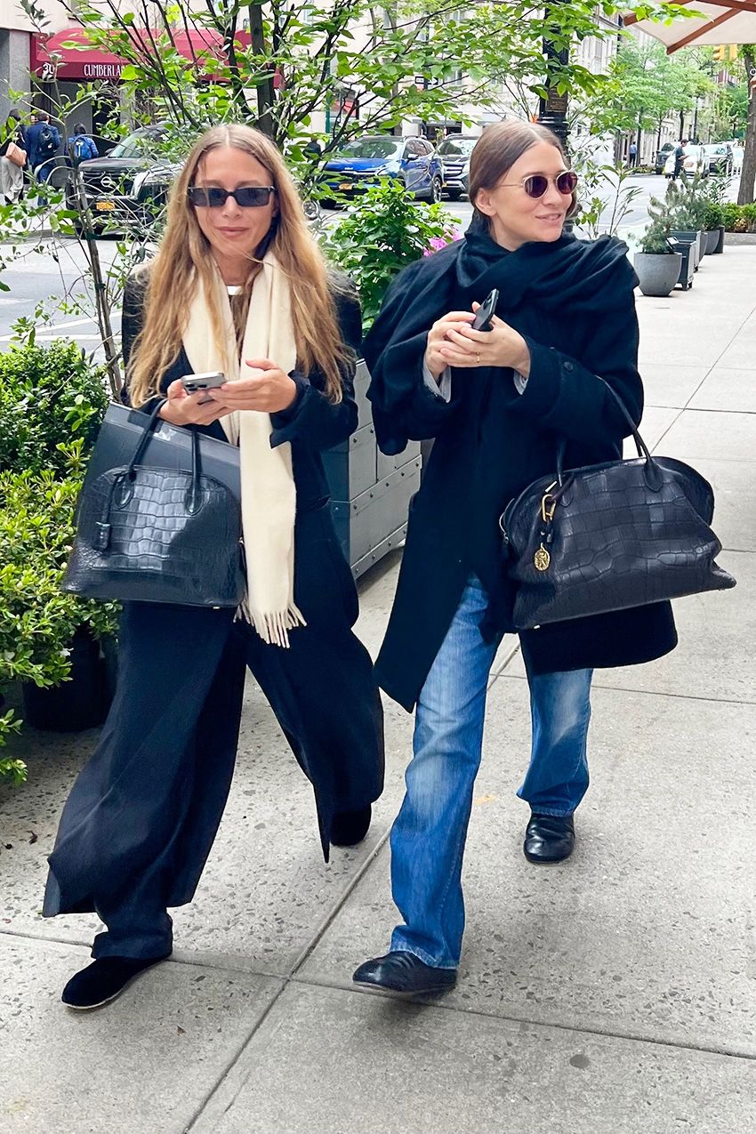 Mary-Kate and Ashley Olsen wearing jackets, scarves, jeans, bowling bags, and flat mules in NYC