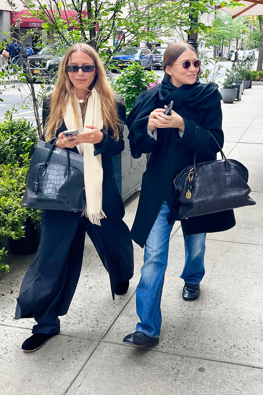 Mary-Kate and Ashley Olsen wearing jackets, scarves, jeans, bowling bags, and flat mules in NYC