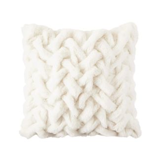 A white cable knit throw pillow