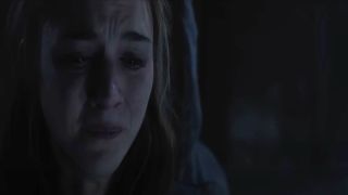 Close up of Chloe East in Heretic hiding and crying.