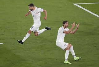 Italy’s Domenico Berardi, left, and Manuel Locatelli celebrate after Turkey’s Merih Demiral diverted the ball into his own net for the opening goal of Euro 2020