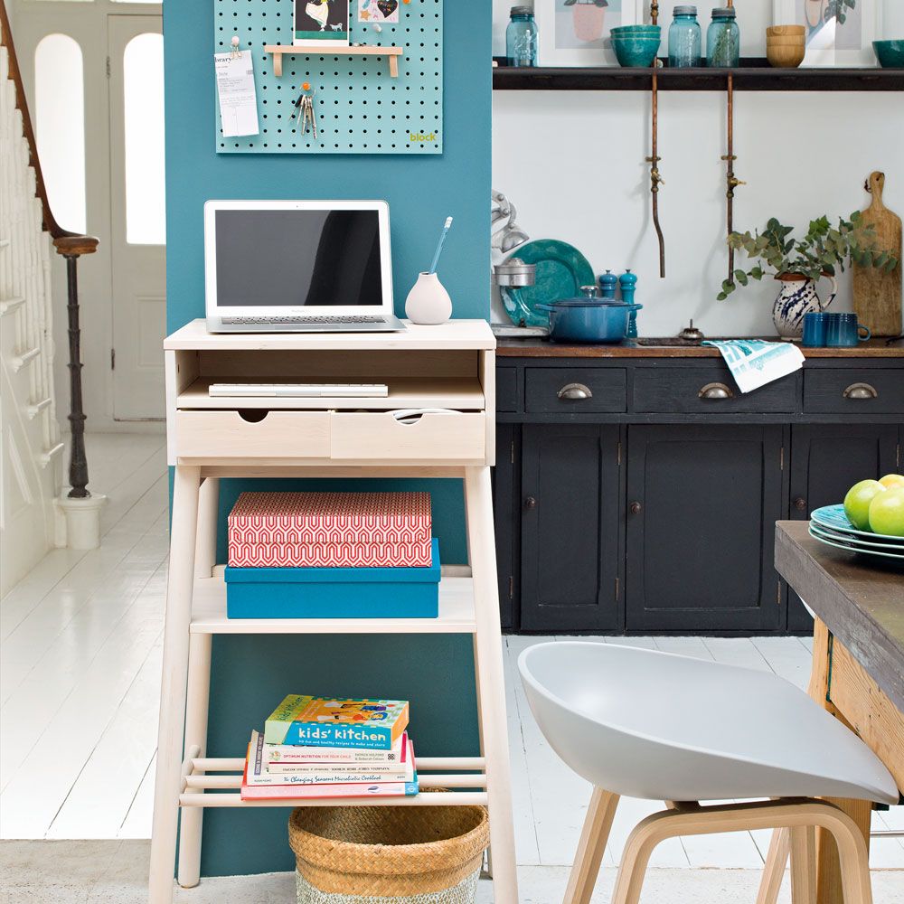kitchen area with white shelve desk and laptop