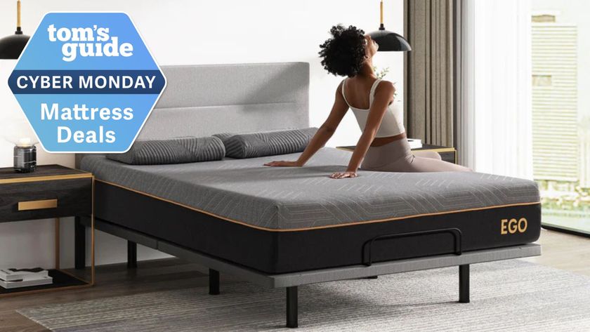 A young woman with black, curly hair relaxes on the EGOHOME Black 12&quot; Hybrid Mattress. A Cyber Monday Mattress Deals badge is seen in the top left foreground. 