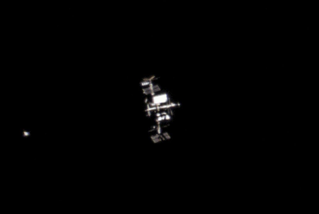 Boeing&#039;s Starliner (left) during Orbital Flight Test 2 as it approaches the International Space Station, as seen in an image taken from London on May 20, 2022.