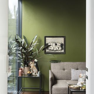 room with earthy green and frame on wall