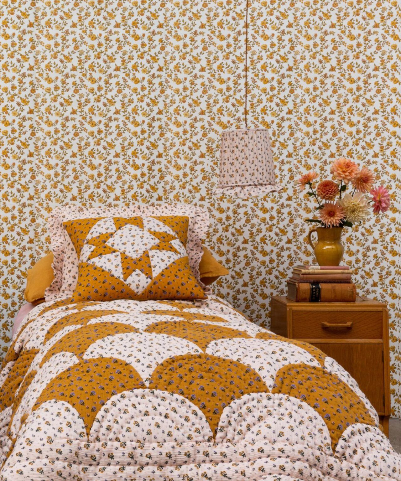 Projektityyny Patchwork Cushions on Single Beds with Patterned Wallpaper