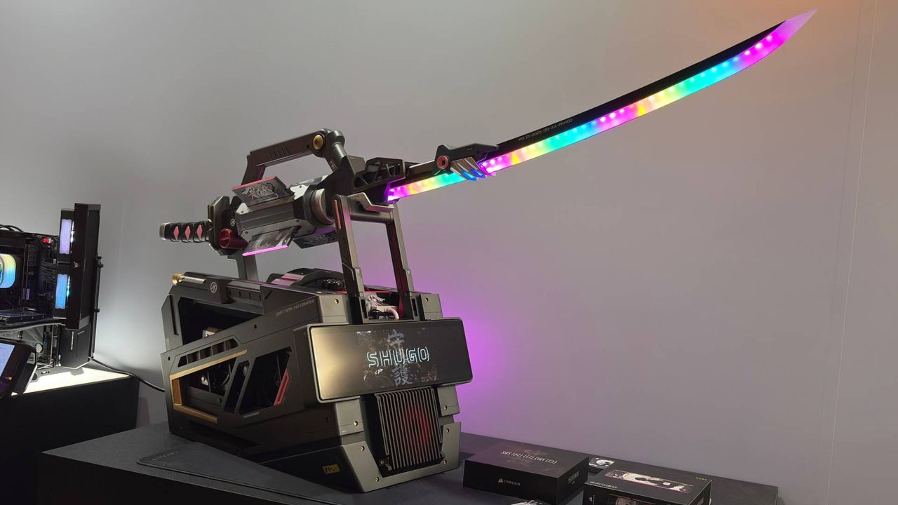 An RGB samurai sword on a pedestal that is actually a PC. The words 'Shugo' can be seen on the wall behind the exhibition piece from Corsair.