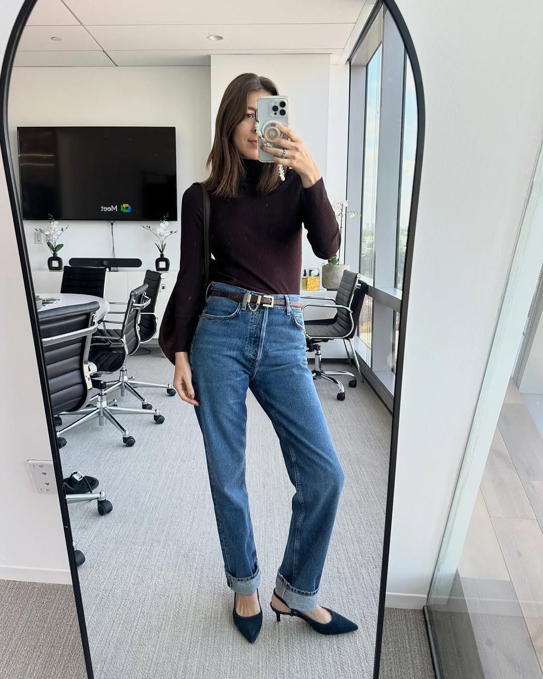 Judith Jones in Agolde '90s Pinch Straight Jeans and a brown turtleneck.