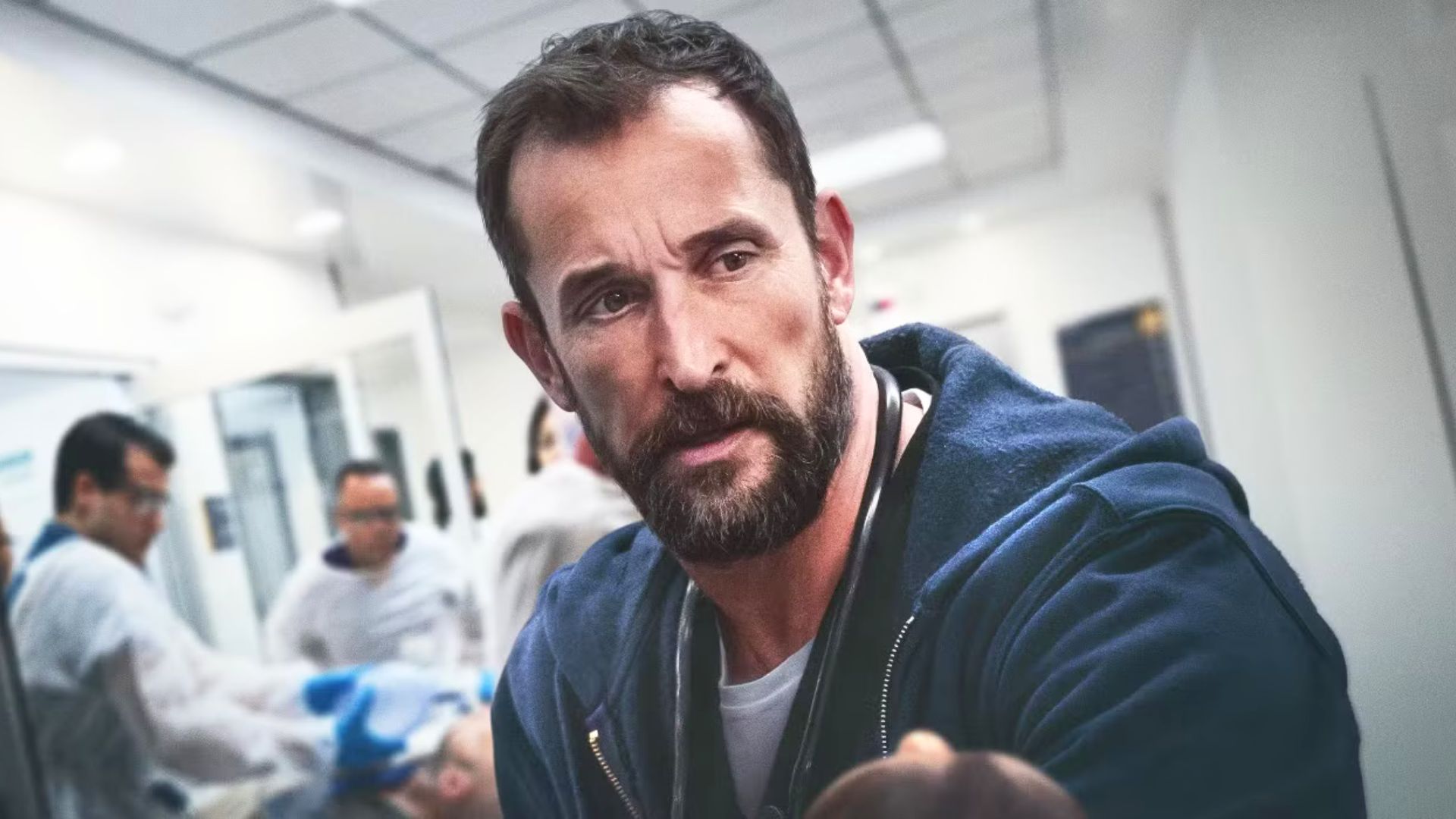 Noah Wyle looks concerned in a hospital hallway