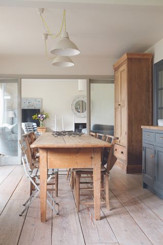 semi open plan dining room and living room with an old farmhouse kitchen table