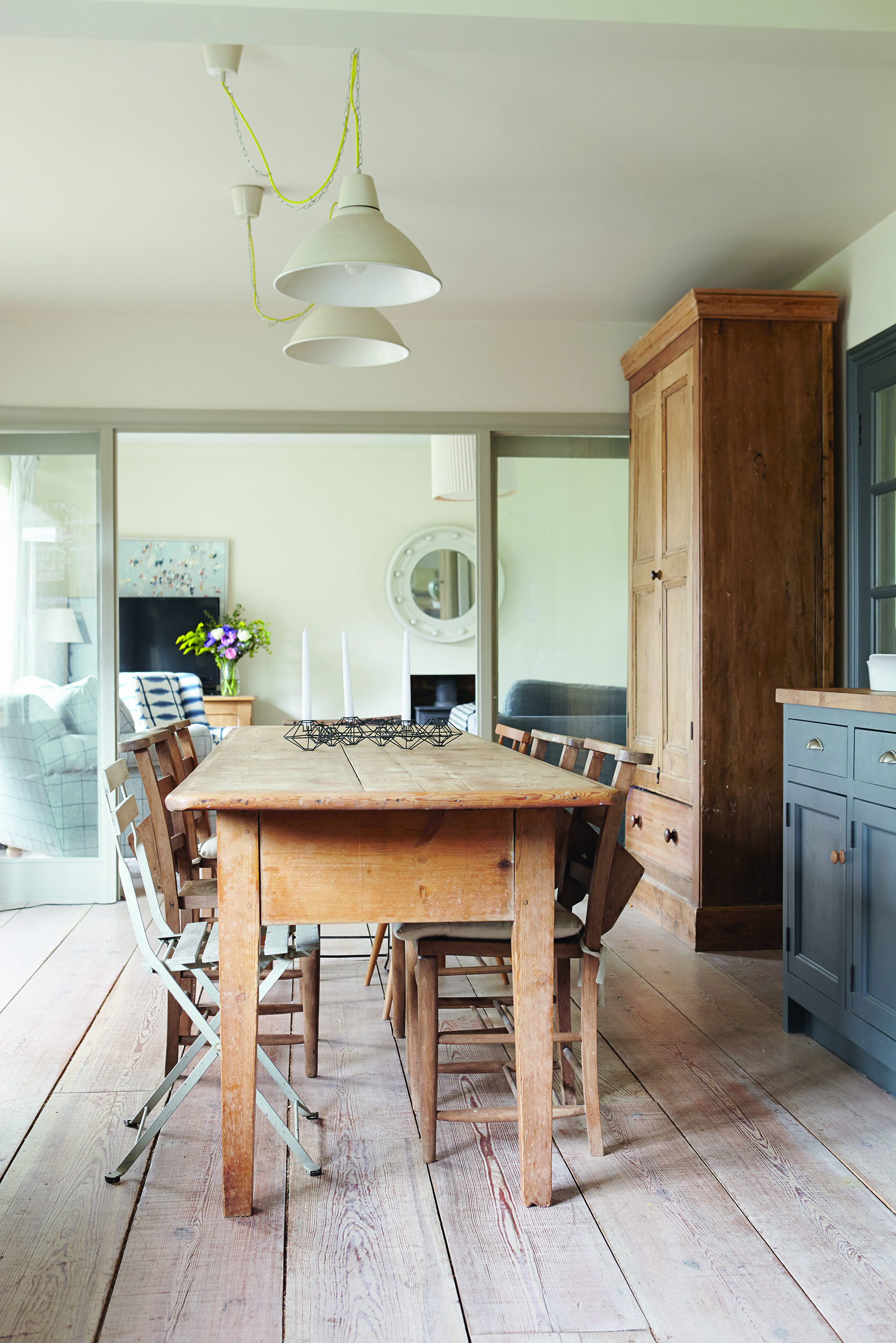 semi open plan dining room and living room with an old farmhouse kitchen table