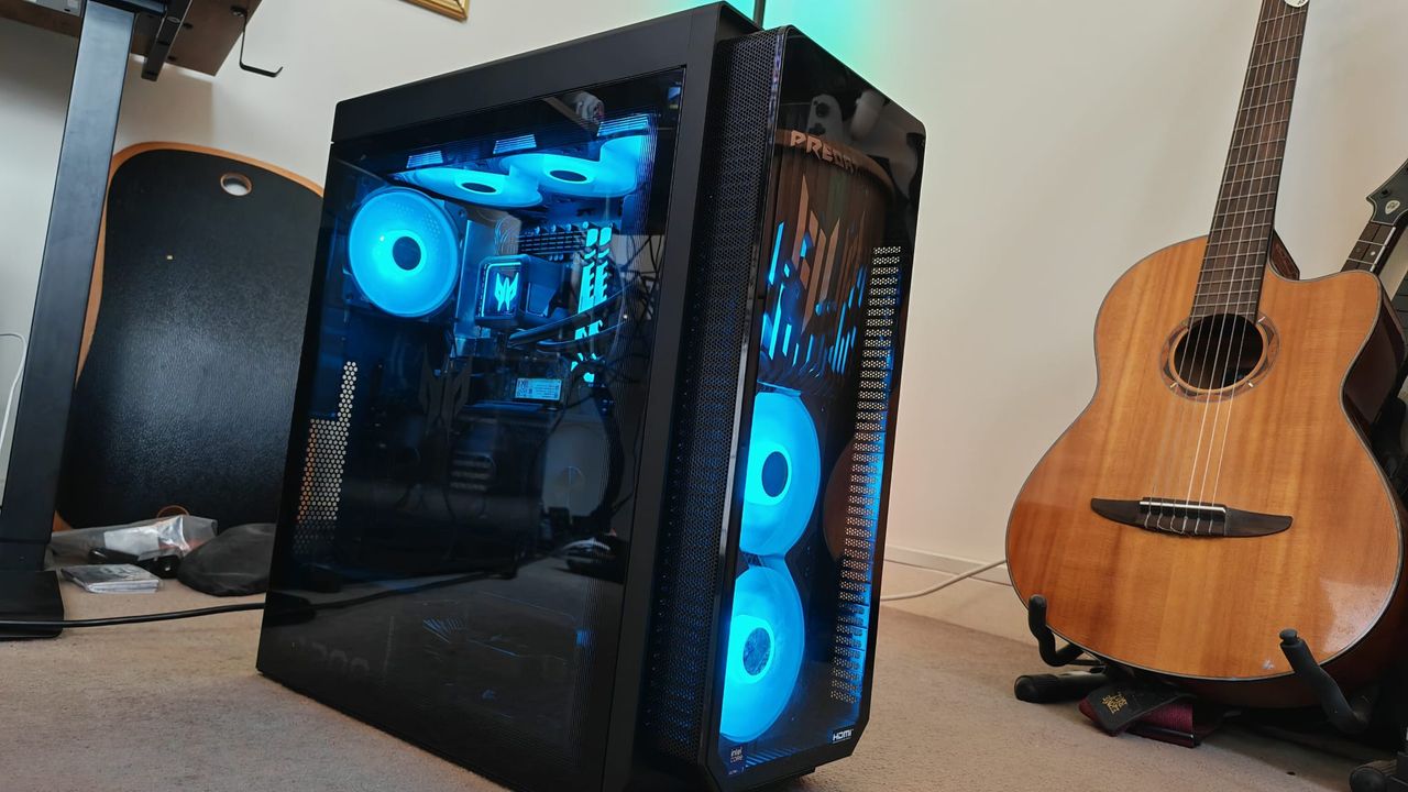 The Acer Predator Orion 7000 (2025) next to a guitar