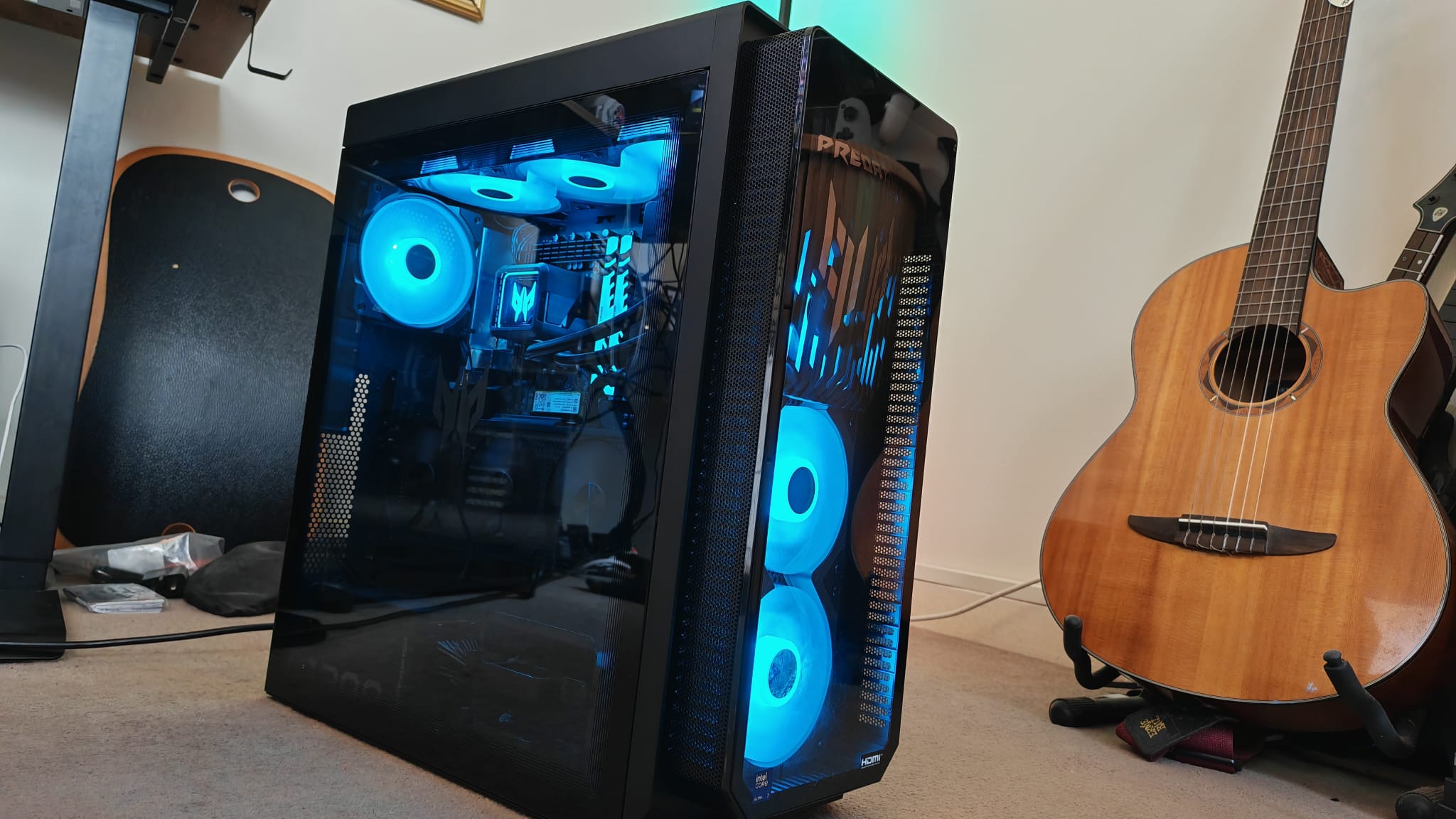 The Acer Predator Orion 7000 (2025) next to a guitar