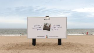 A Polaroid billboard encouraging an analog summer