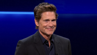 Rob Lowe smiling into camera hosting The Floor Season 6