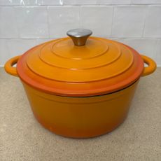 Orange cast iron pan on white countertop