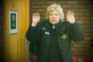 Jan Jenning holds up her hands in fear when she's held at gunpoint in Casualty.