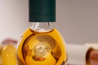 Close-up of Louis XIII The Drop in mini glass bottle with green top
