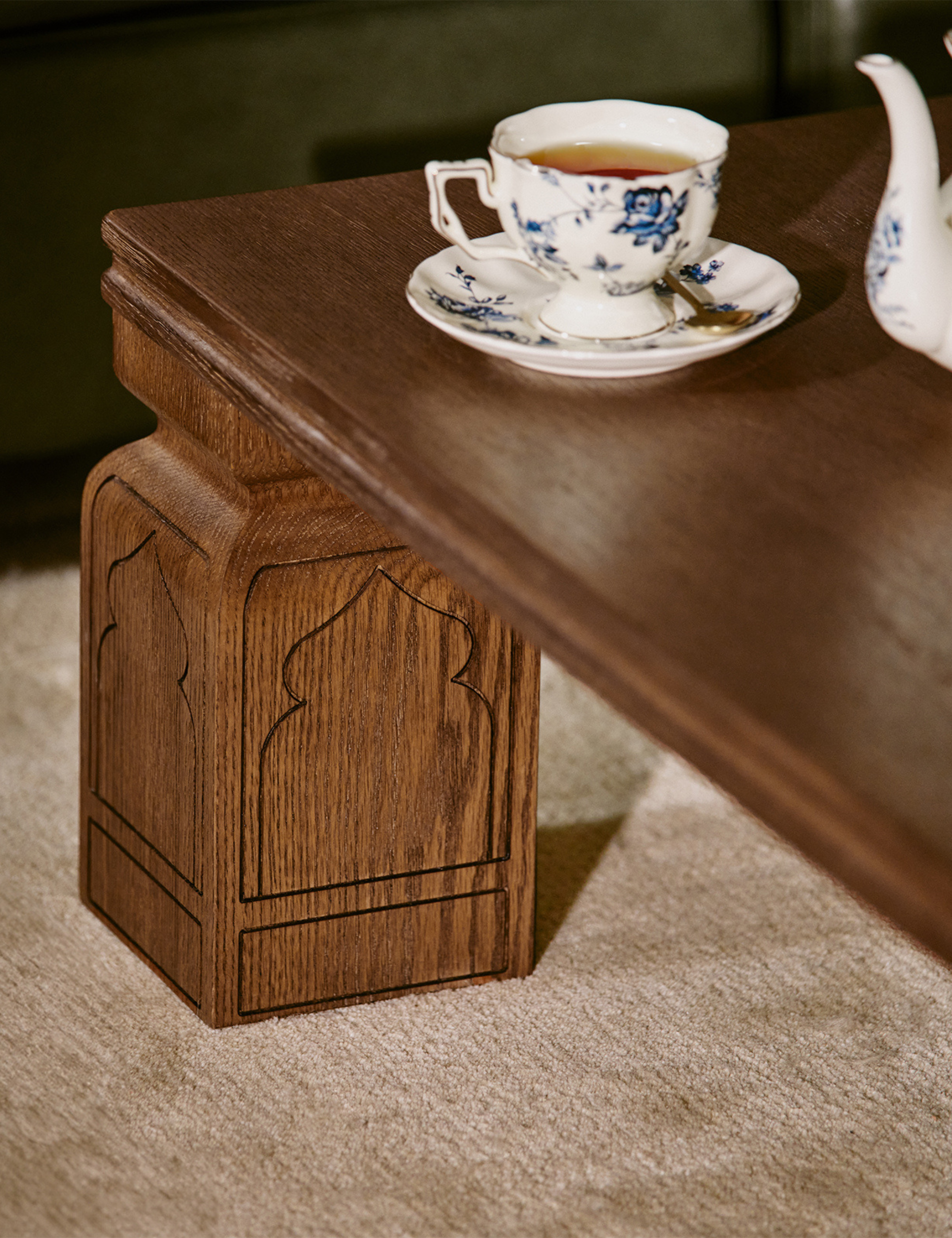 Close up shot of Tan France's Anaya wooden tea table styled with a floral tea set