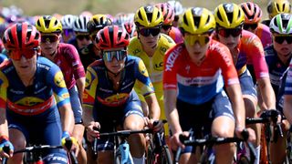 The peleton of the Tour de France Femme with the yellow jersey rider in the middle.