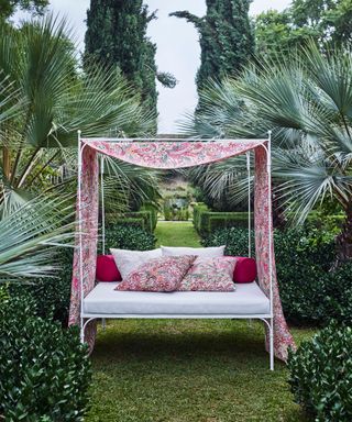 day bed with patterned fabric in garden setting