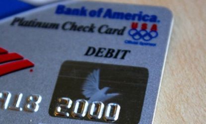 Bank of America will initiate $5 monthly debit card fees starting early next year, and customers are threatening to walk out on the banking giant.