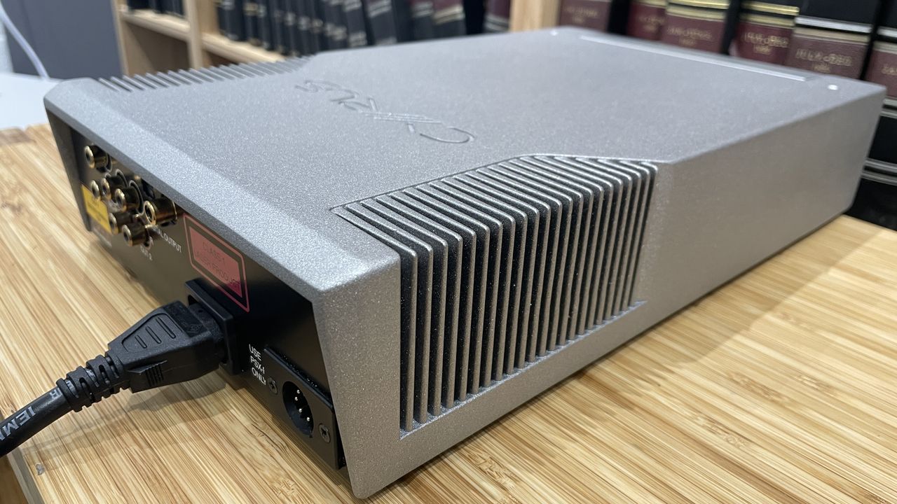 Cyrus CDi player on wooden rack with magazines in background