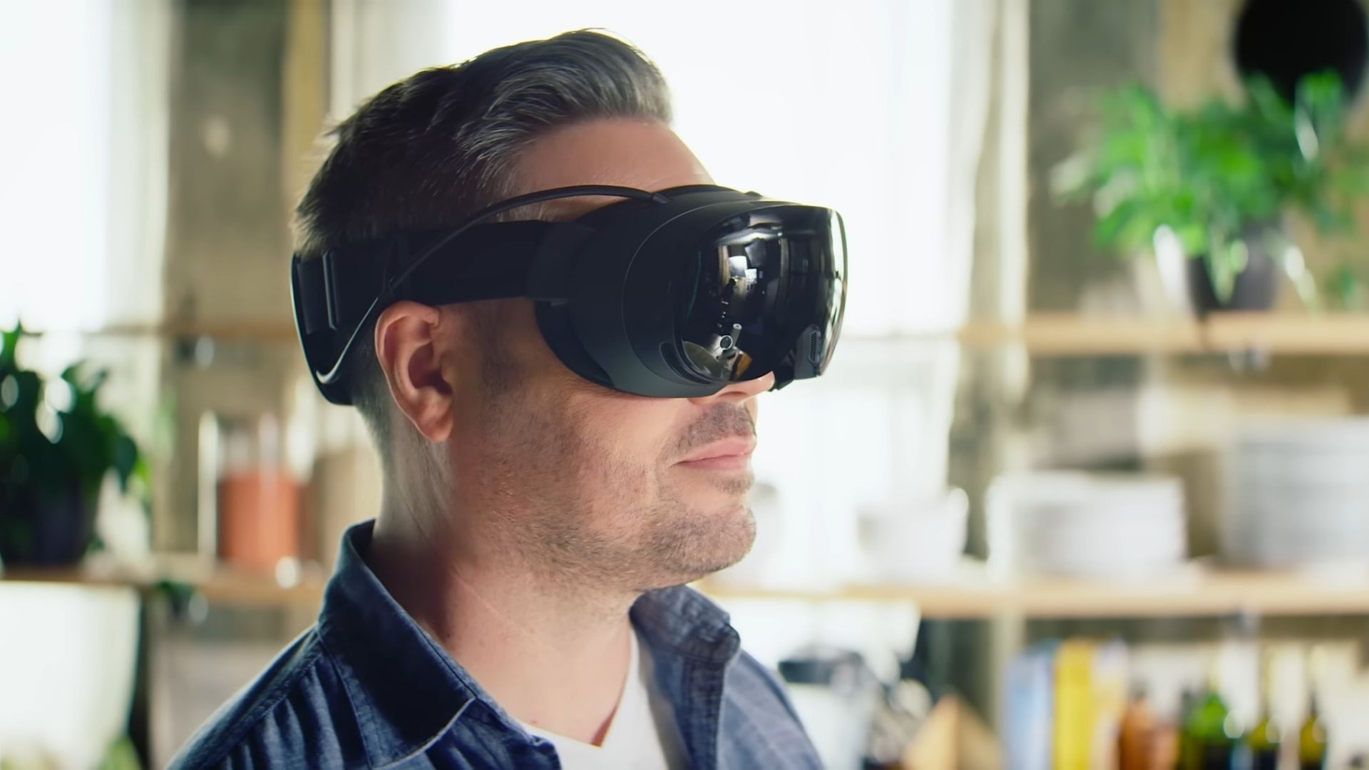 A man facing away from the camera, wearing a Steam Frame