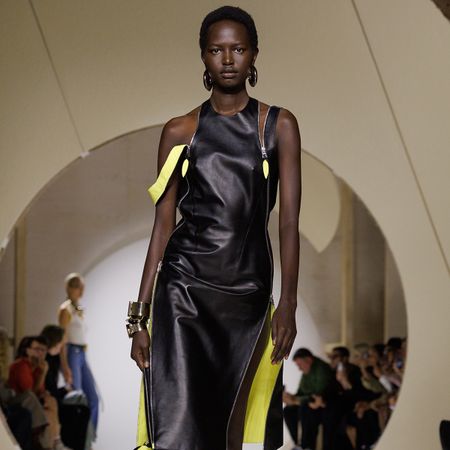 a model wears a black leather dress.