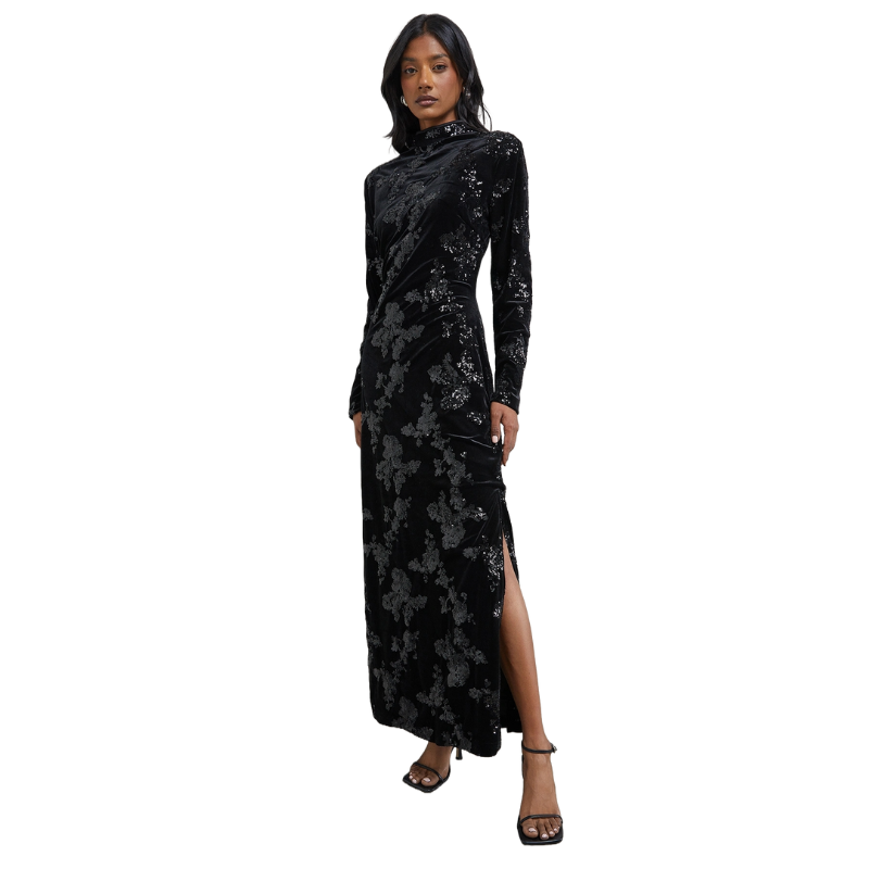 A woman wears a a black sequin maxi dress