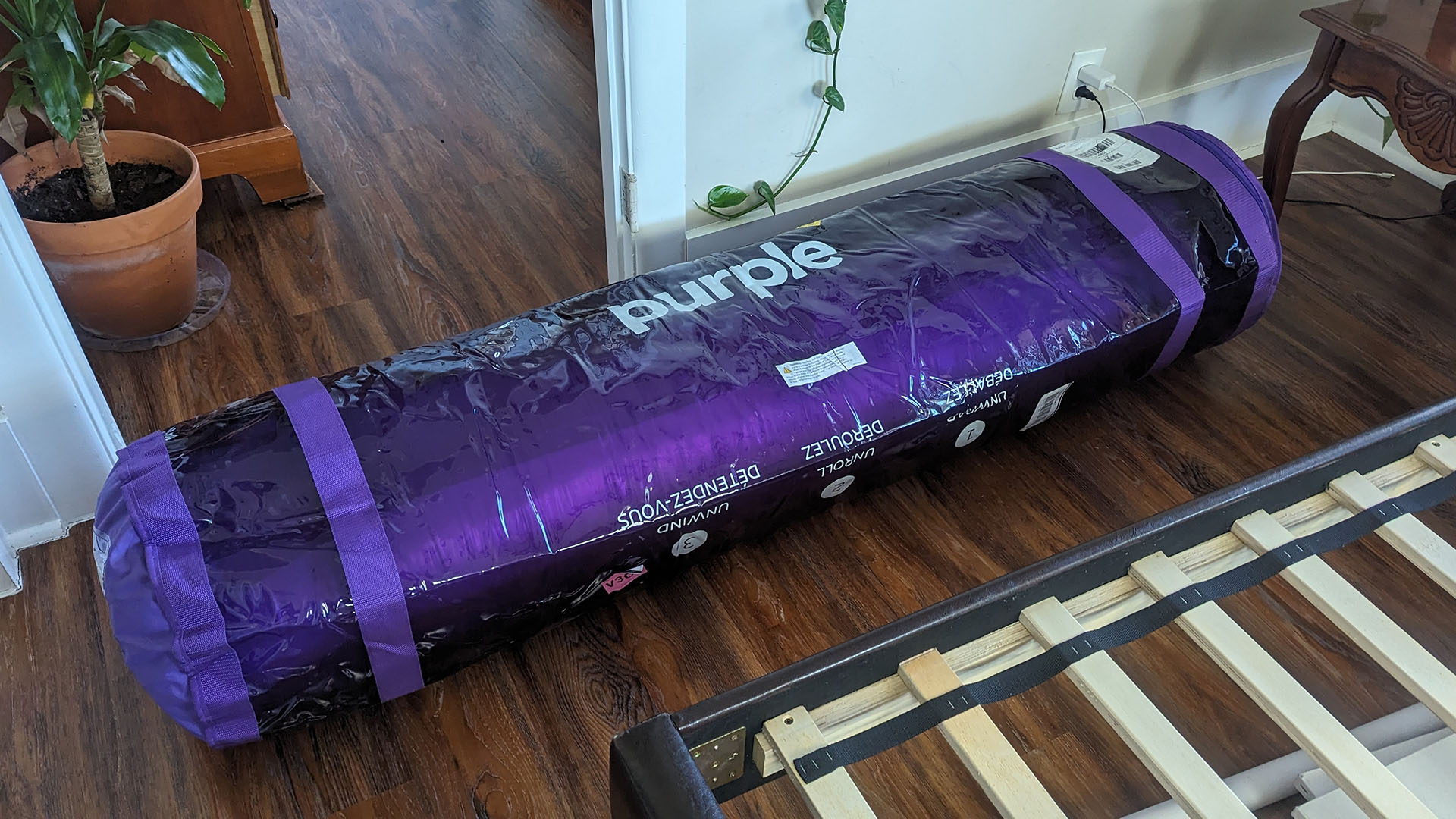 Purple NewDay mattress, vacuum-packed and rolled in a reusable plastic bag