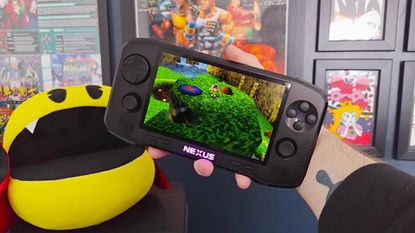 Hand holding Evercade Nexus with Banjo-Tooie gameplay on screen.