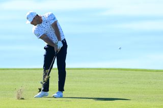 DeChambeau hits an iron shot