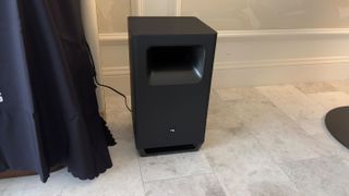 Nakamichi soundbar, surround speakers and subwoofers set up in a hotel suite