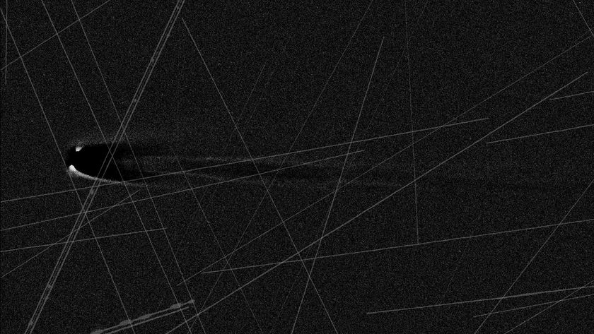 An image of a comet in black and white with lines streaking across the image. 