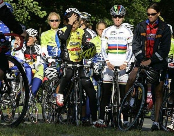 Cyclists stand in silence