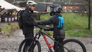 A young rider taking advice from a coach