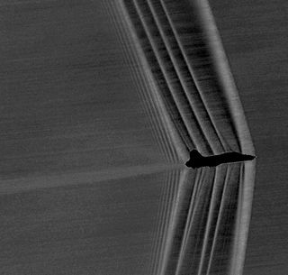 A U.S. Air Force T-38 plane moving at Mach 1.05 generated shock waves that were captured by a photography technique.