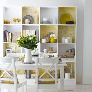 Yellow wallpaper in white shelves