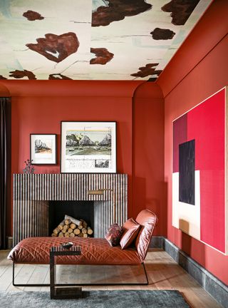 Red living room with fireplace and wallpapered ceiling