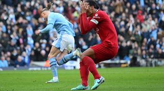 Virgil van Dijk holds his head after a mistake from the Liverpool defence allows Erling Haaland to score for Manchester City in November 2023.